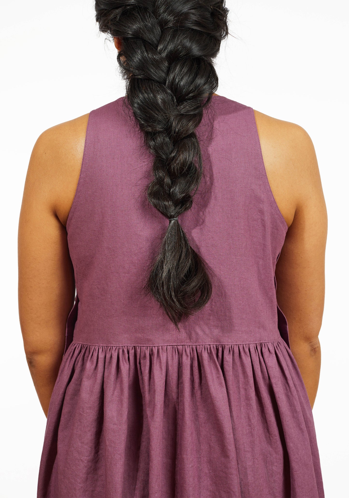 Close-up of back bodice and gathered skirt seam on mauve linen Austin Dress.