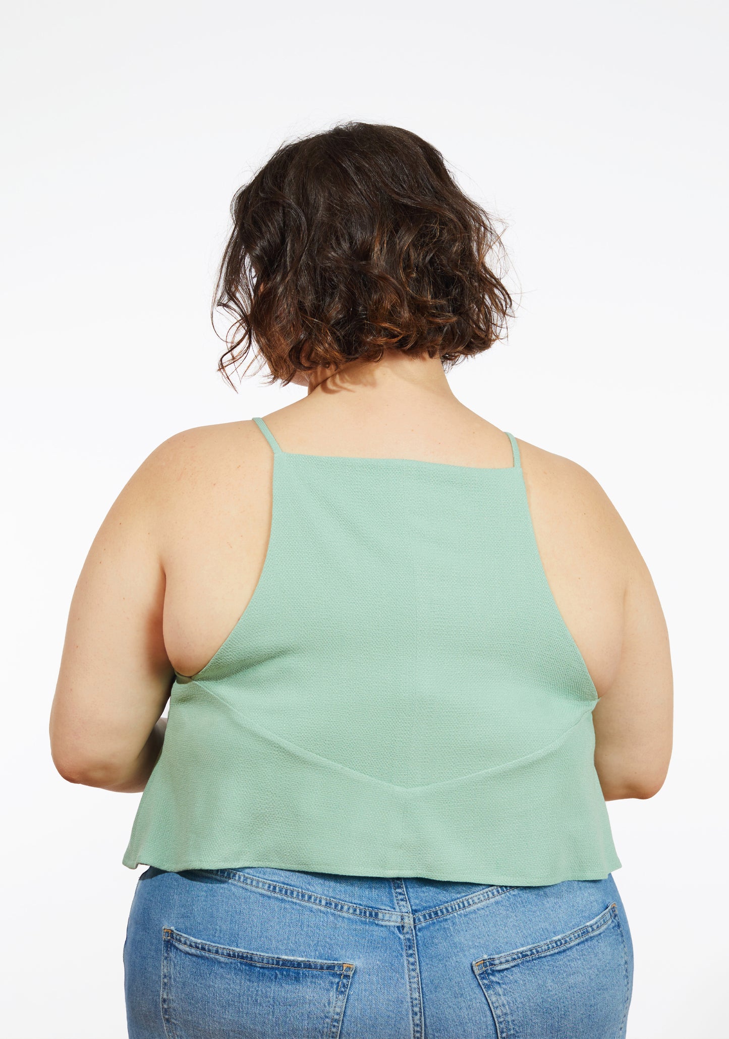 Back view of Myra Top in green textured fabric with narrow straps and curved back seam.