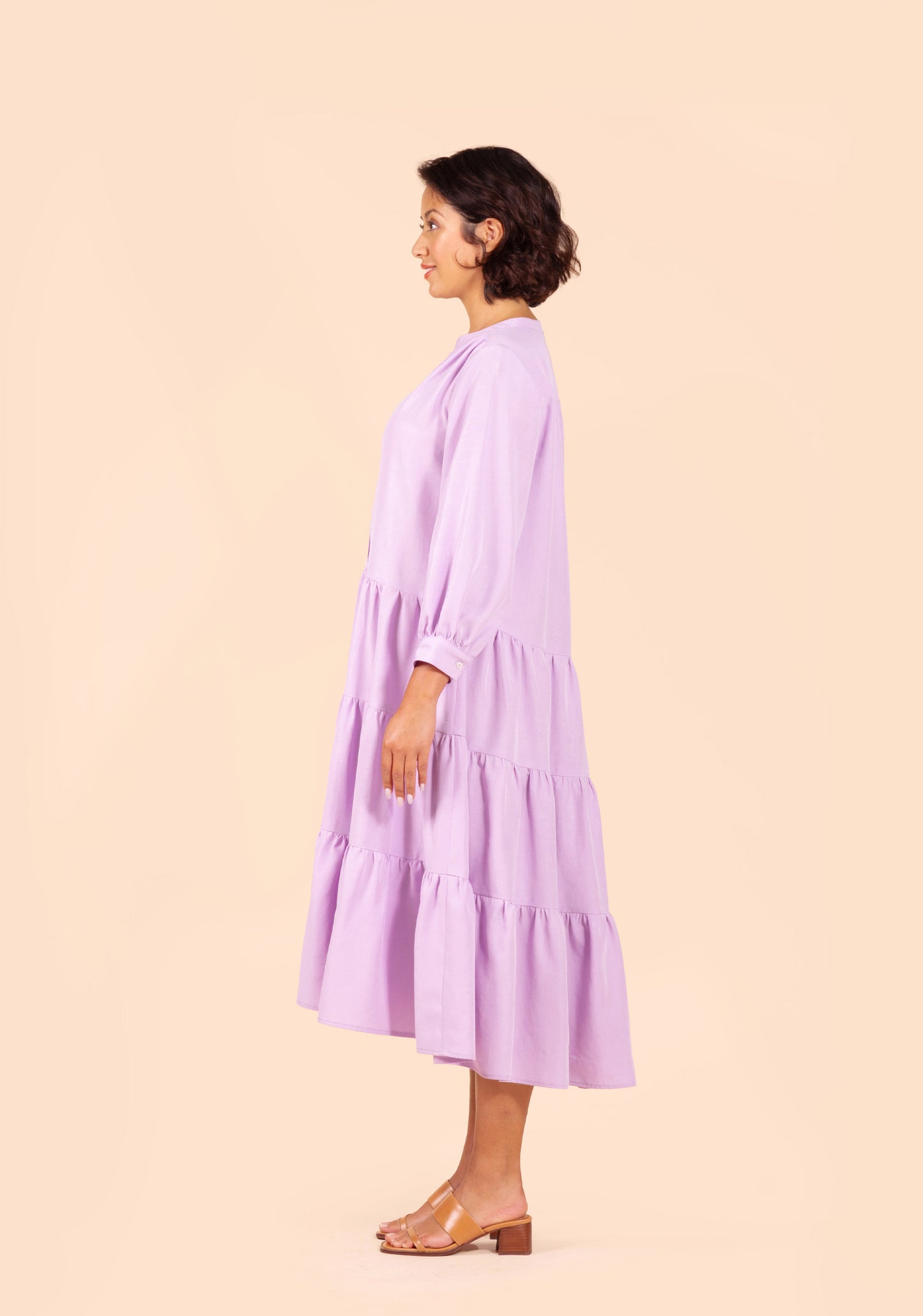 Side view of Poppy Dress View D in lilac fabric with full skirt and long sleeves.