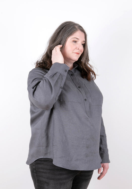 Model wearing Archer Popover shirt in charcoal, front view showing placket and chest pockets.