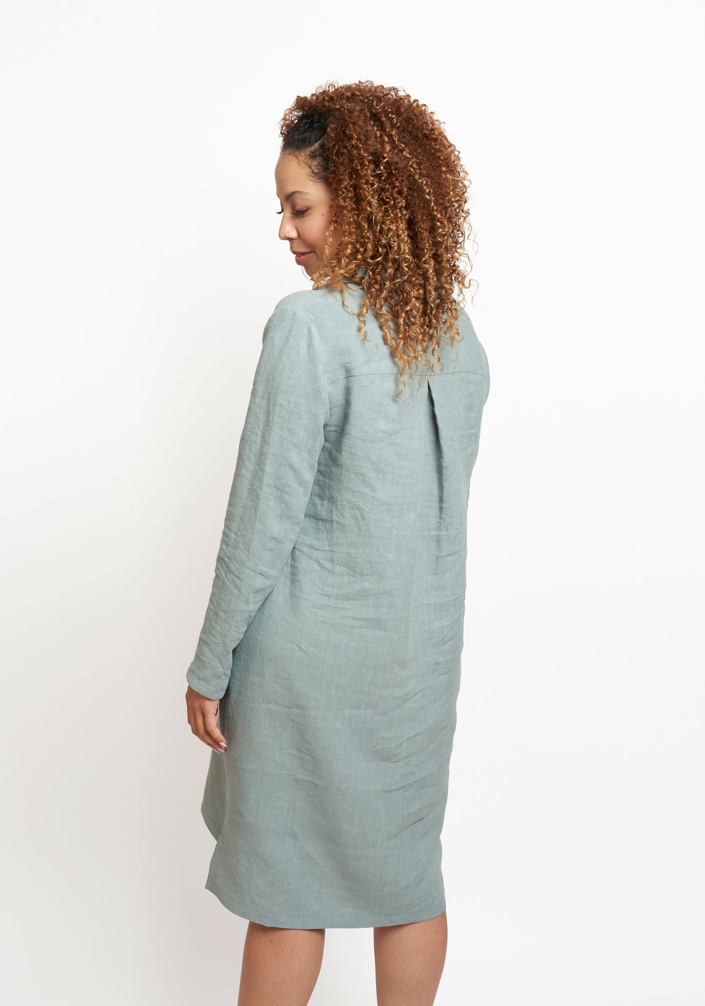 Back view of blue-green Augusta Dress, showing pleated yoke and gentle shaping through the body.