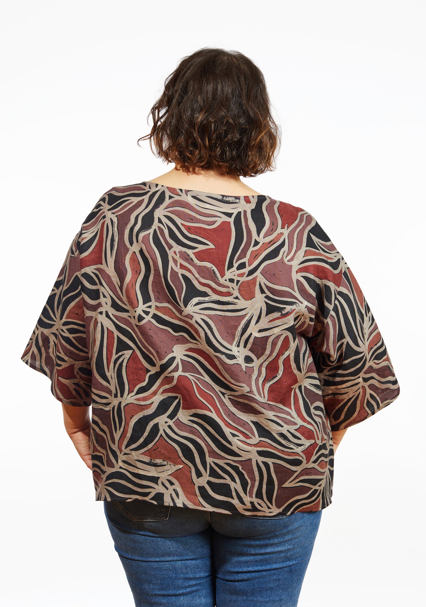 Back view of Corin Top in abstract batik print with wide sleeves and relaxed fit, worn by model.