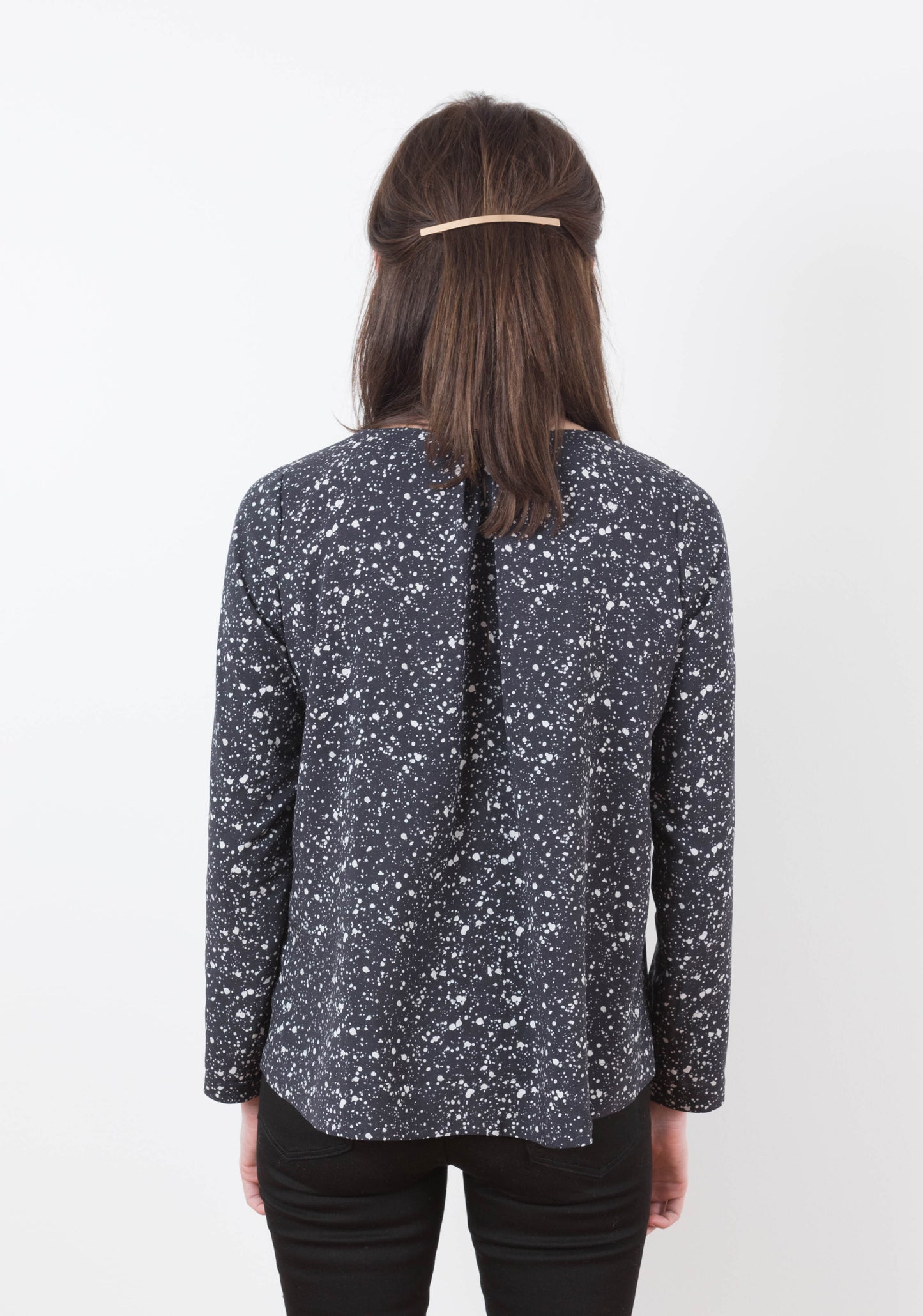 Back view of the Hadley Top in long sleeves with center pleat detail, worn by model.