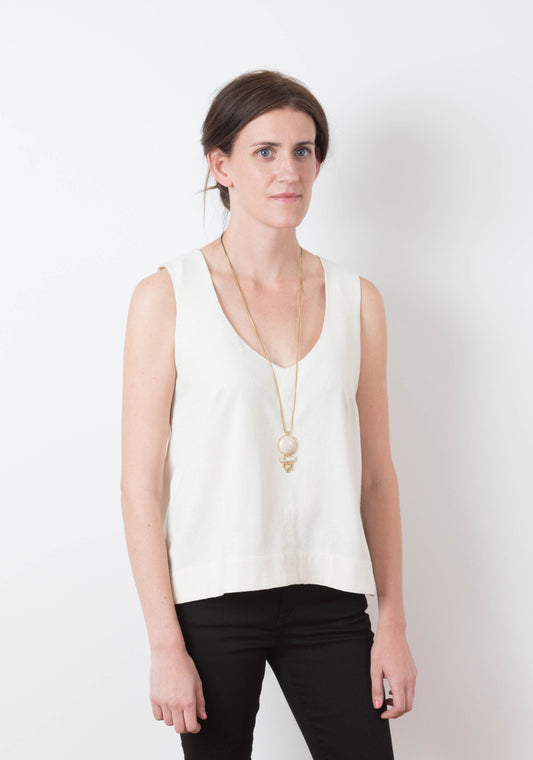 Front view of sleeveless Hadley Top in white with deep V-neckline, worn by model.