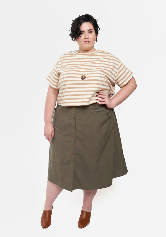 Front view of Reed Skirt in olive fabric with button front and angled pockets.
