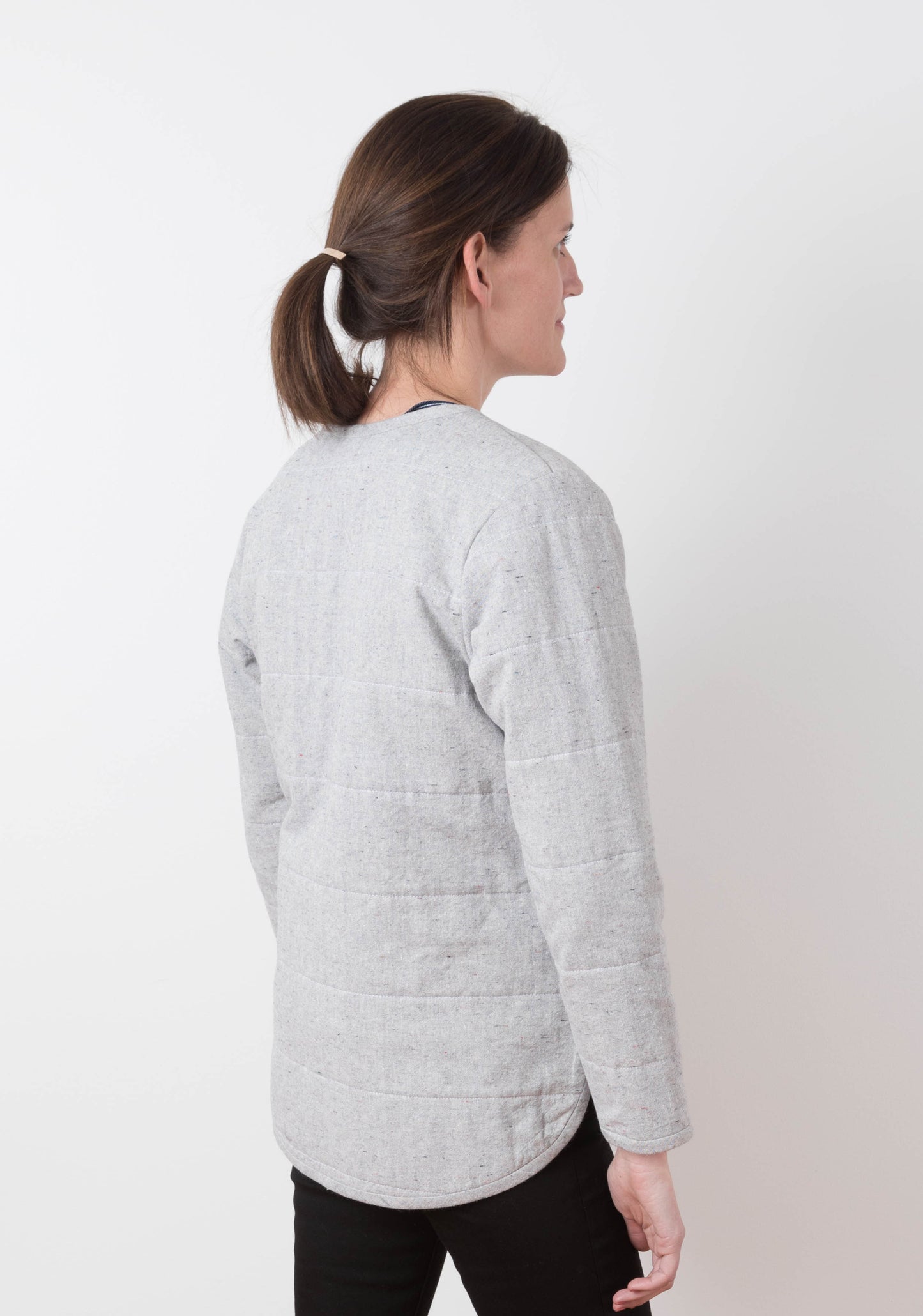 Back view of gray quilted Tamarack Jacket in View B with horizontal quilting and rounded hem.