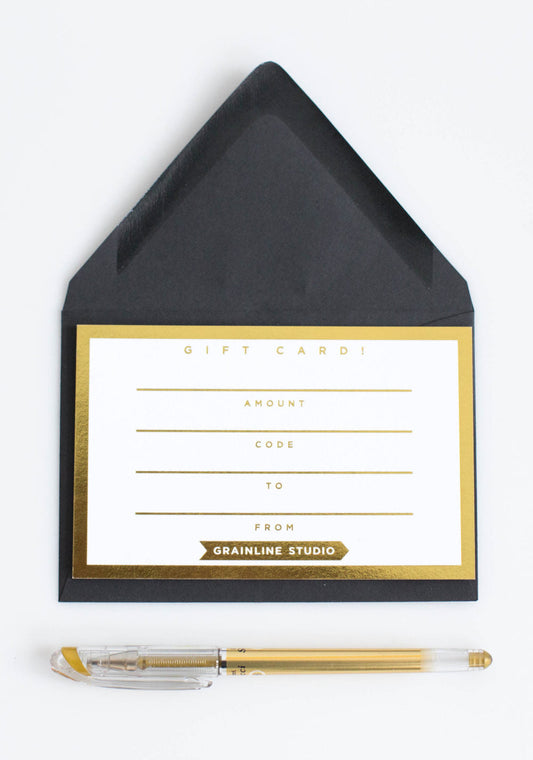 Grainline Studio gift card with black envelope and gold border, blank fields for amount, code, to, and from