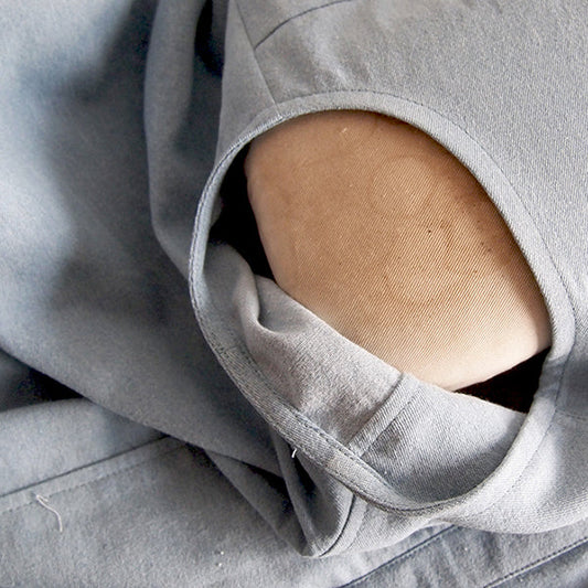 Close-up of light-wash denim Alder Shirtdress armhole facing, bias strip folded, pressed, and sewn to the underside