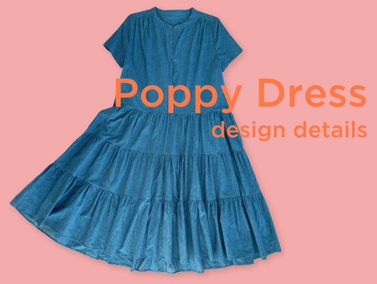 Blue short sleeved, swingy, three tiered skirt dress laying on a pink background. Poppy dress sewing pattern