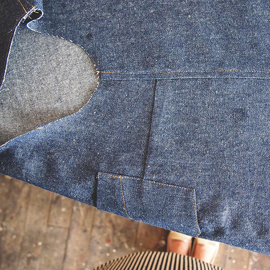 Alder Shirtdress in dark denim showing a faux flat-felled side seam, front dart, and patch pocket