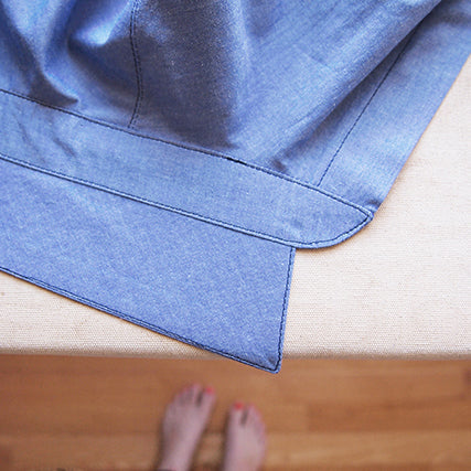 Blue chambray Archer Button-Up collar and collar stand with visible edgestitching, laid flat on a work surface