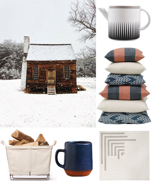 Winter mood board with a snowy log cabin, navy and terracotta pillows, canvas log basket, ceramic mugs, and a quilted throw