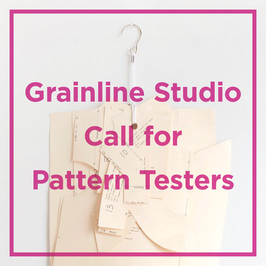 Grainline Studio Call for Pattern Testers graphic with oaktag sewing pattern pieces on a pattern hook and magenta text overlay