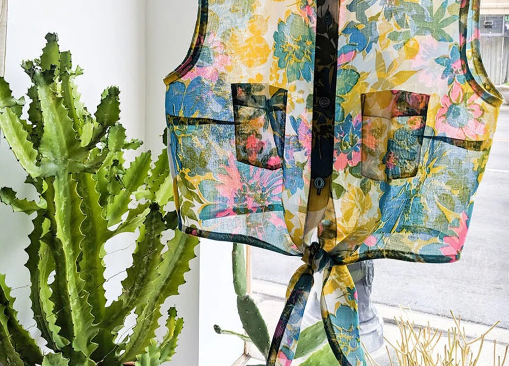 Tie-front Alder shirt on dress form in colorful floral print with bias-bound edges, shortened to cropped length with tied front