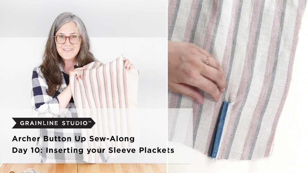 Woman holding up a striped linen sleeve beside hands smoothing a finished blue sleeve placket on striped fabric