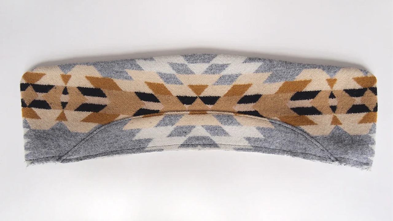 Completed collar with gray collar stand attached to geometric print wool showing topstitching along curved seam