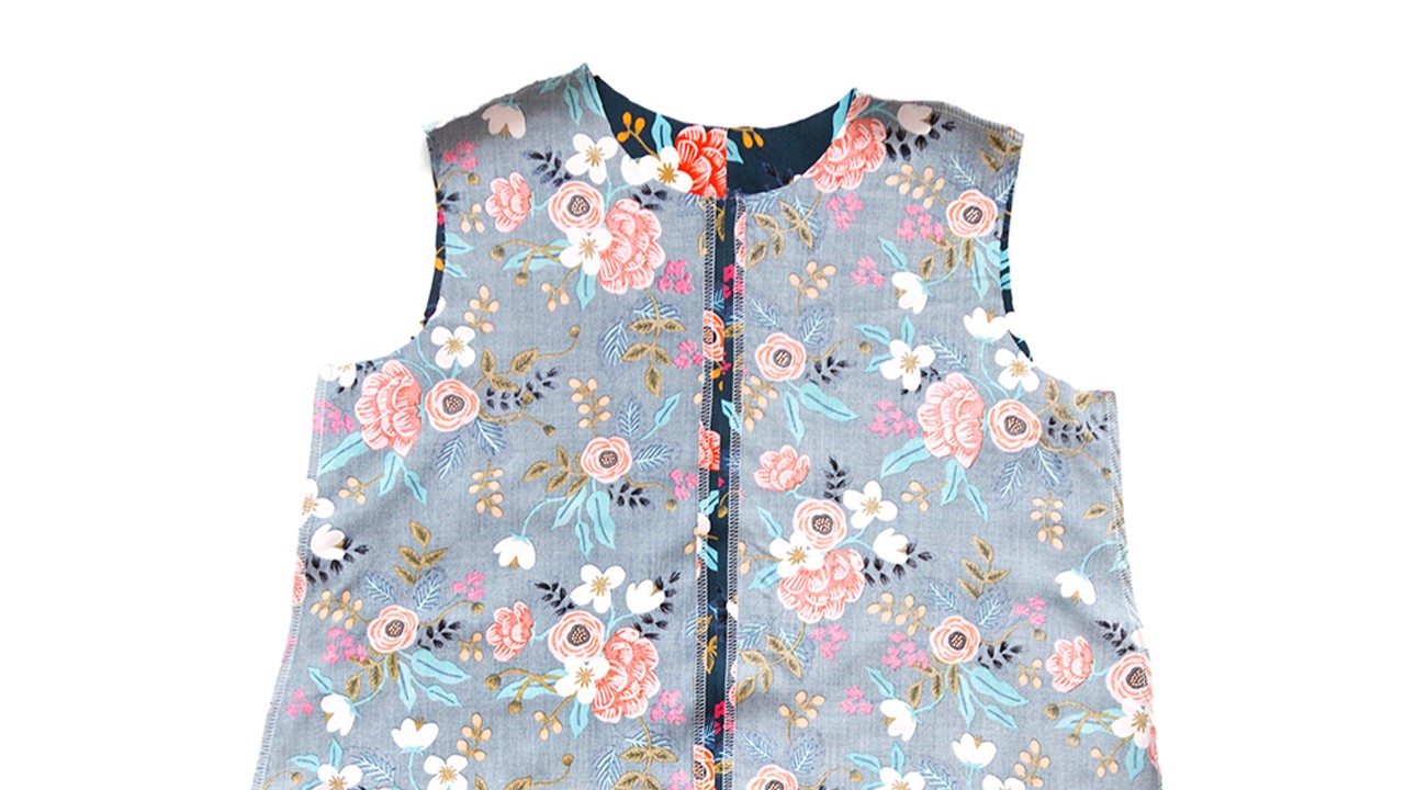 Blue floral Farrow Dress bodice showing completed shoulder and side seams with serged edges joining front and back pieces together.