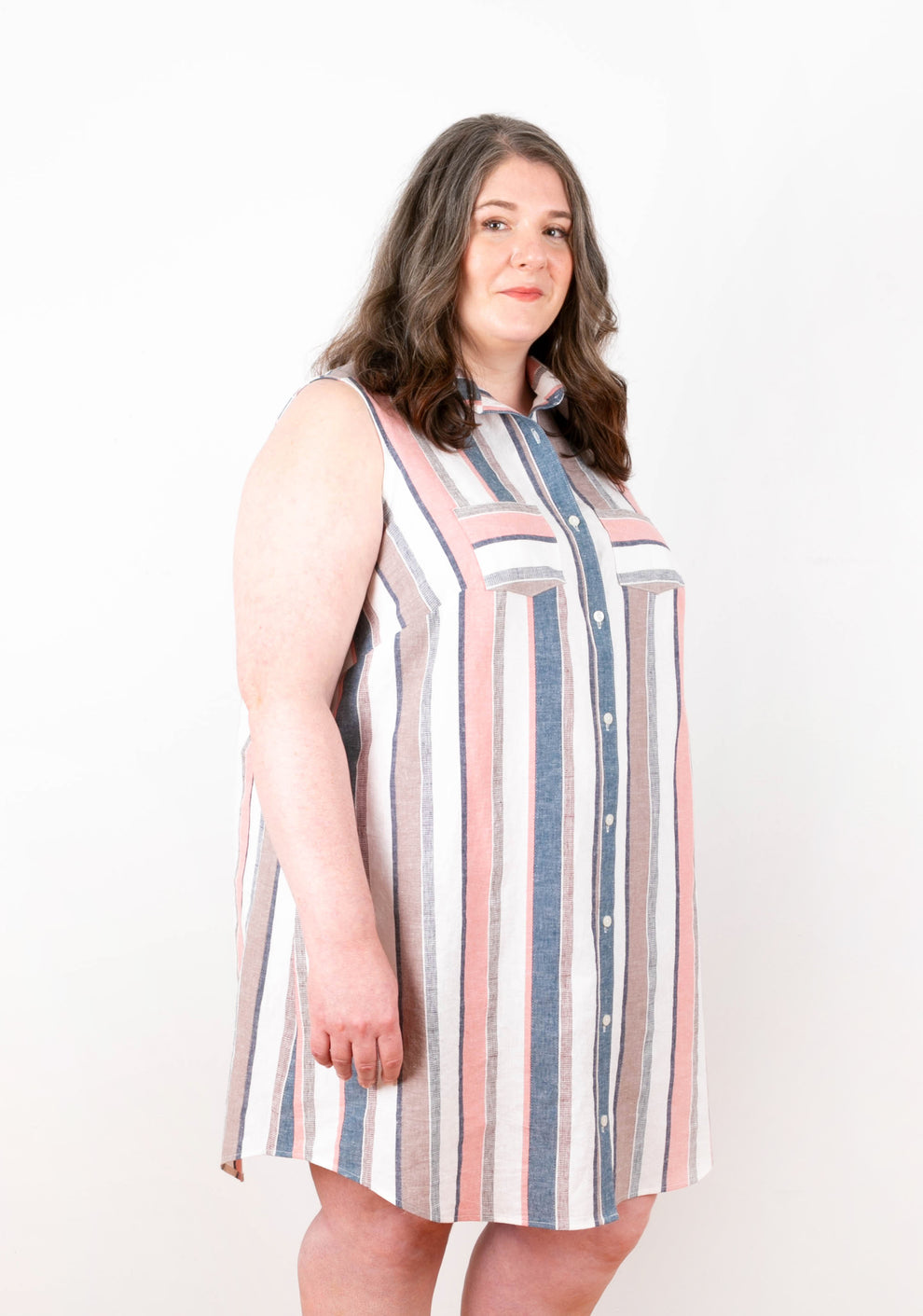 Angled front view of Alder Shirtdress View A in striped fabric with chest pockets and button placket.