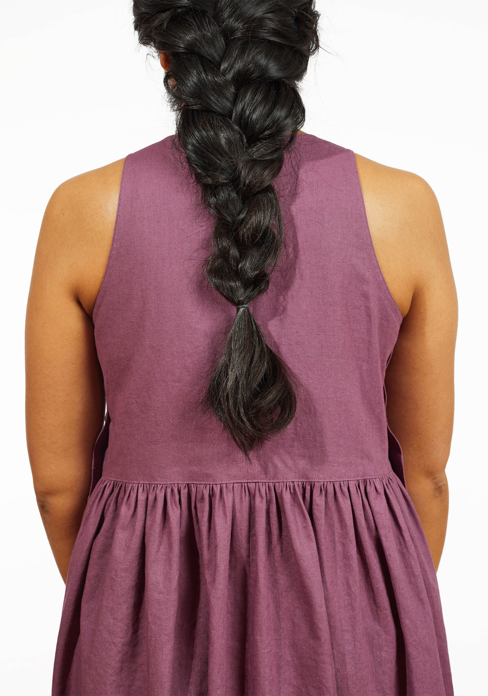 Close-up of back bodice and gathered skirt seam on mauve linen Austin Dress.