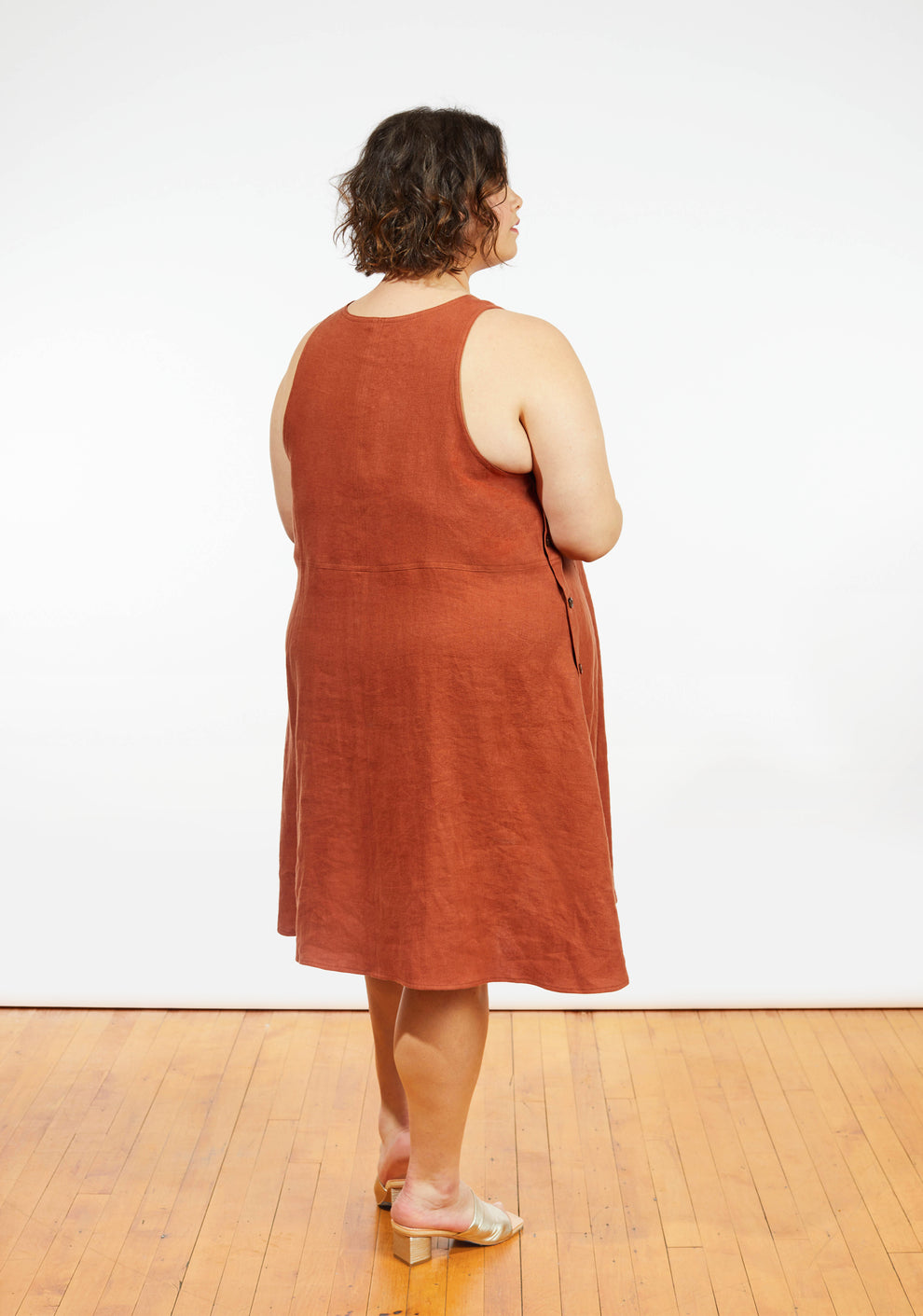 Back view of Austin Dress in rust linen showing racerback-style sleeveless design.