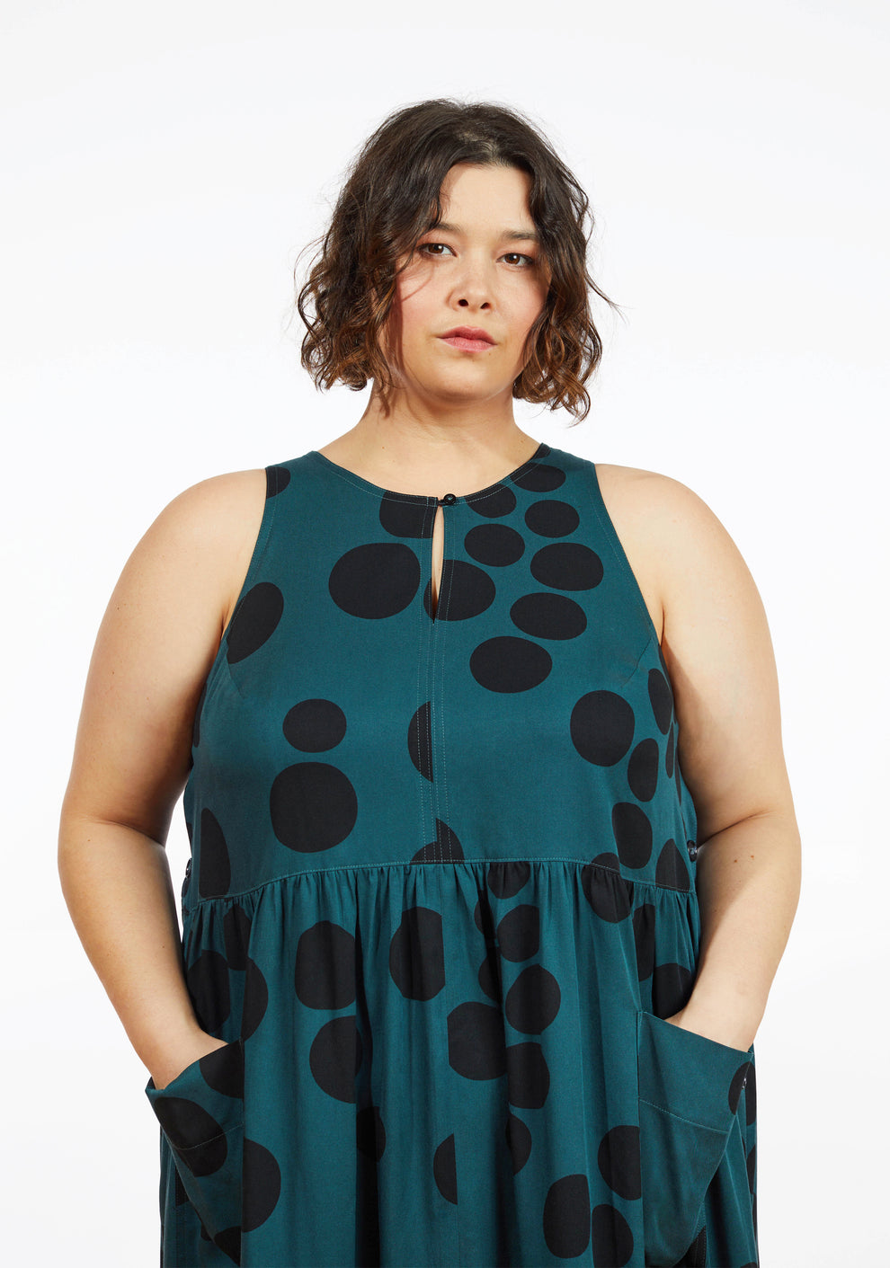 Close up of neckline and bodice on Austin Dress in teal dot print showing keyhole opening and sleeveless design.