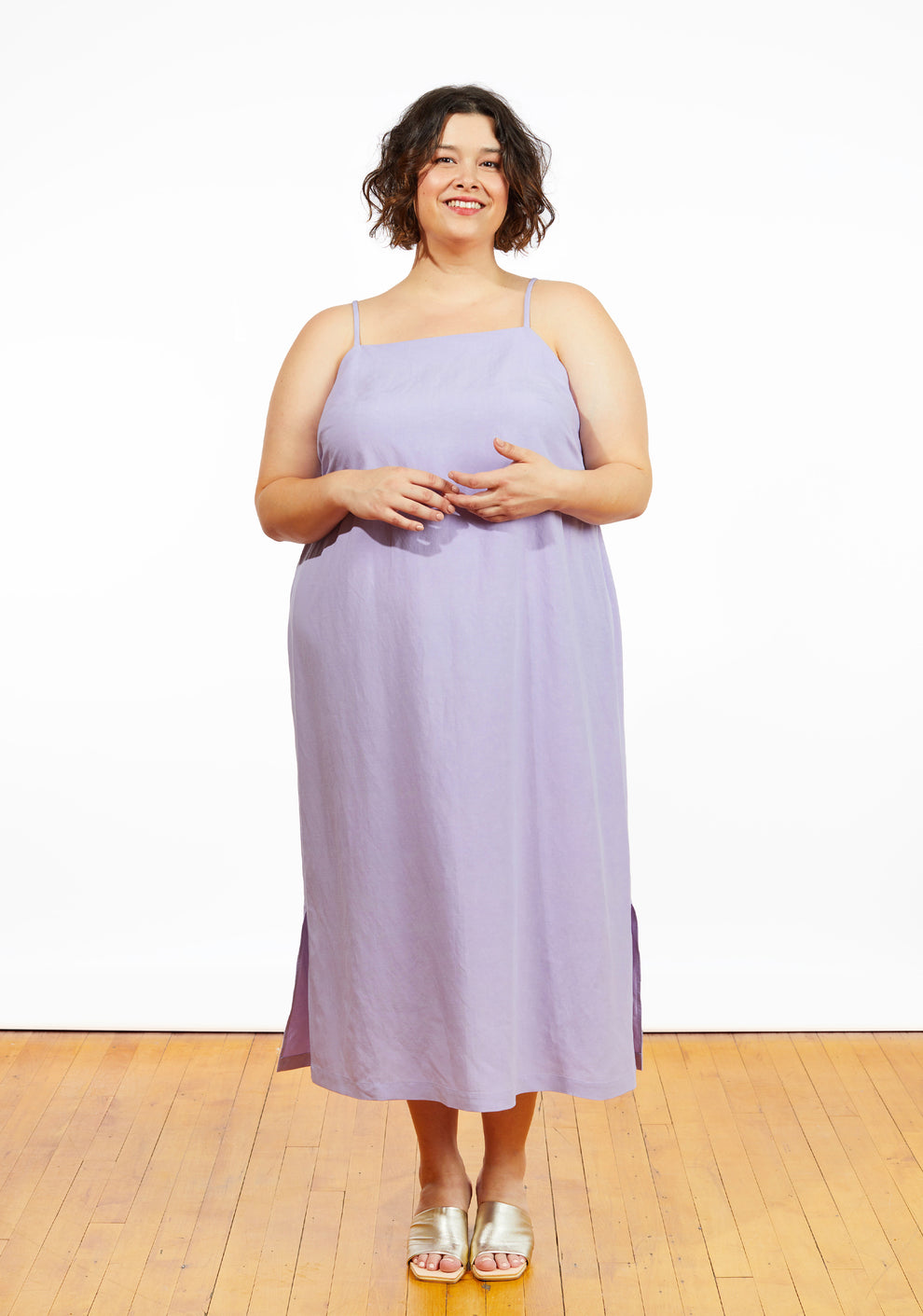 Model: Size 24, 5'5" | Full body front view of model wearing Myra Dress in lilac, featuring midi length and narrow straps.