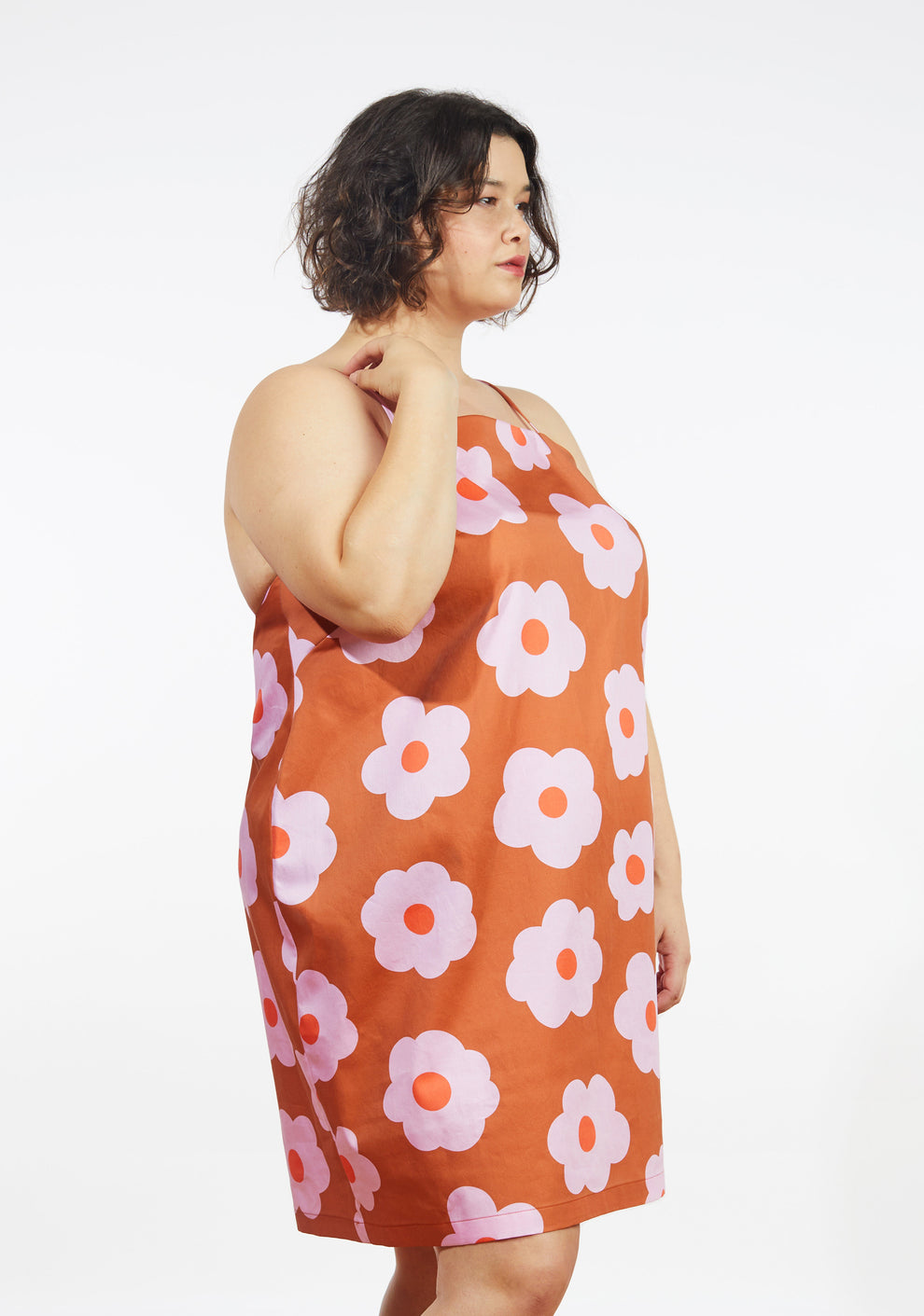 Side view of Myra Dress in orange floral print with spaghetti straps and straight neckline.