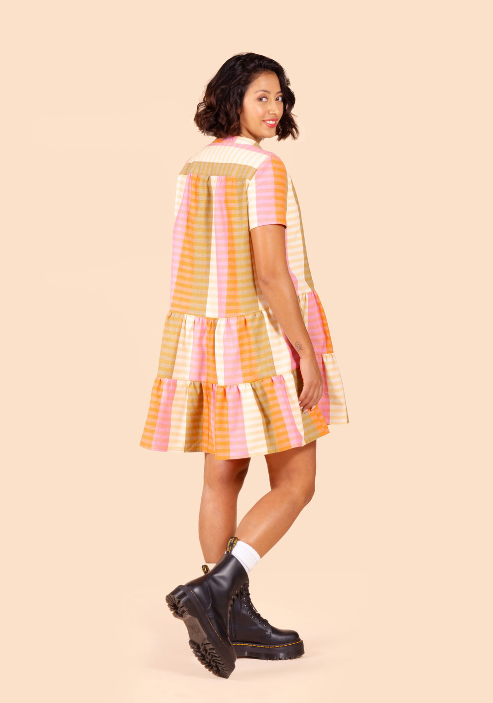 Back view of the Poppy Dress showing gathered yoke and two-tiered skirt in striped fabric.