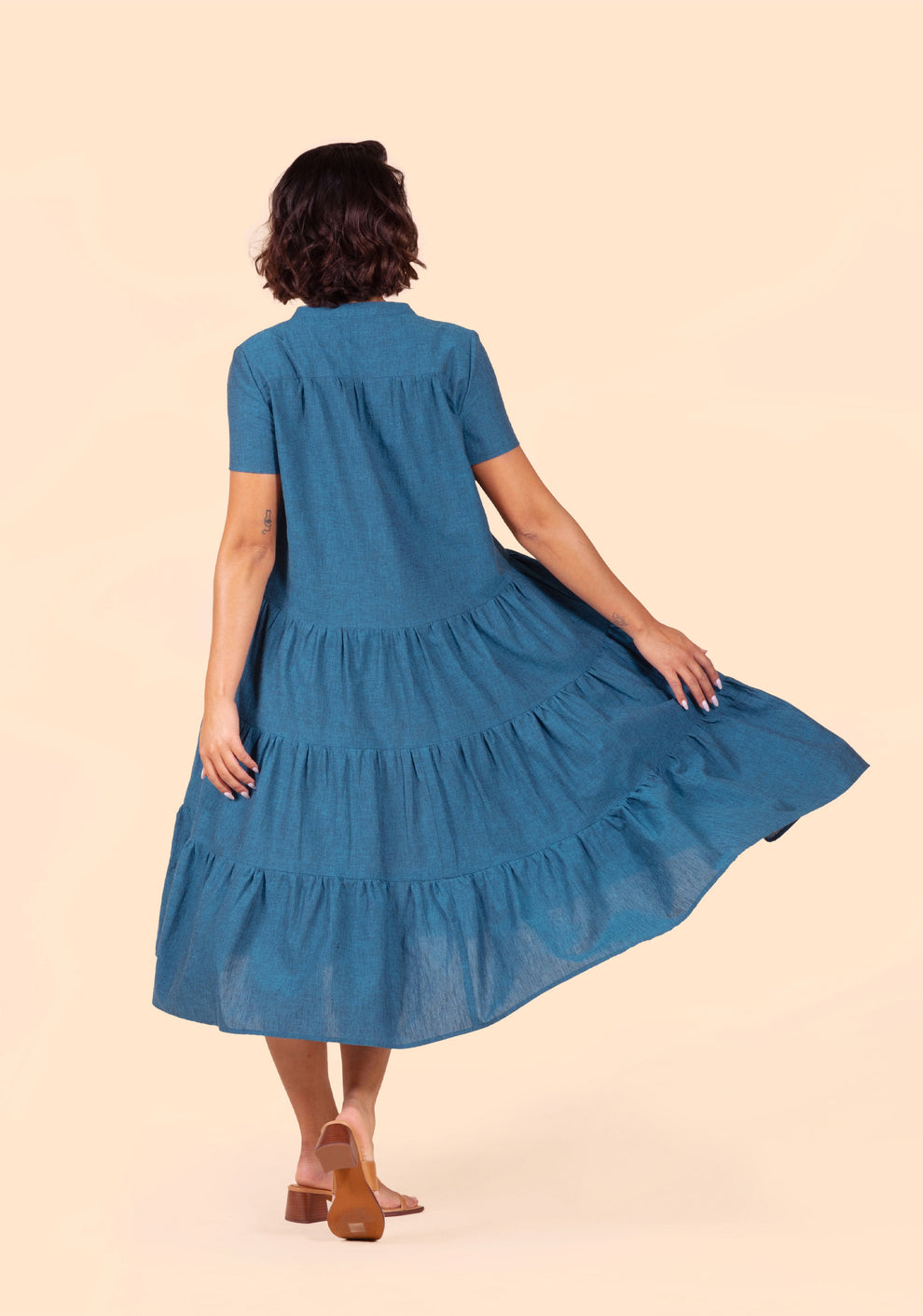 Back view of the Poppy Dress View C highlighting three gathered tiers and back yoke in teal fabric.