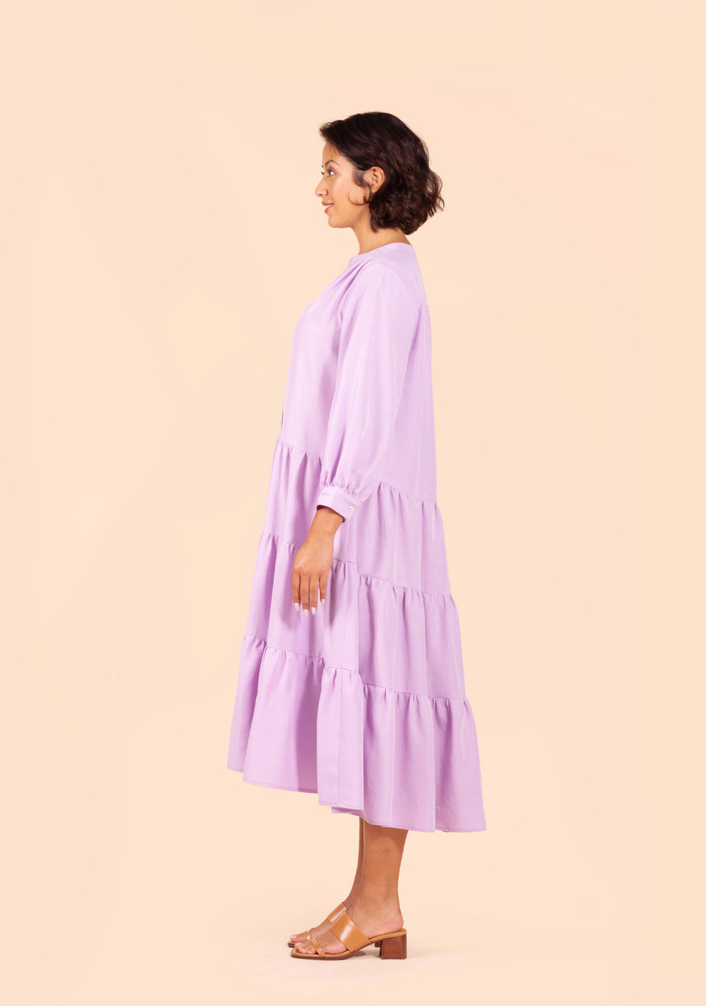 Side view of Poppy Dress View D in lilac fabric with full skirt and long sleeves.