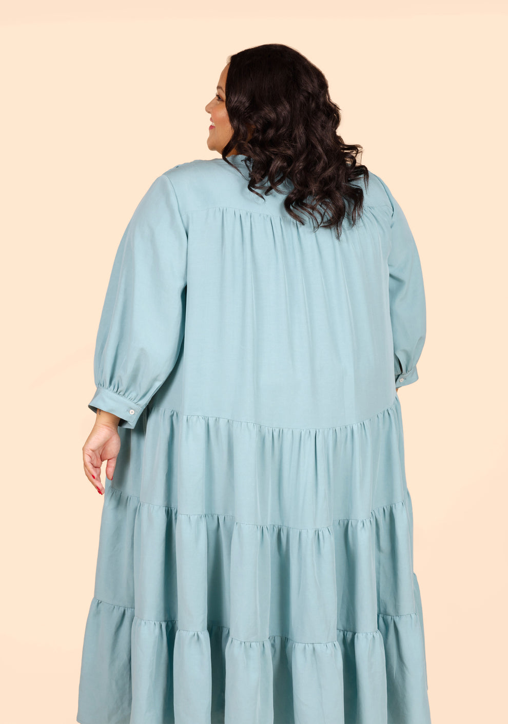 Back close-up of long Poppy Dress View D in blue solid cotton, showing gathering at yoke and sleeve cuff.