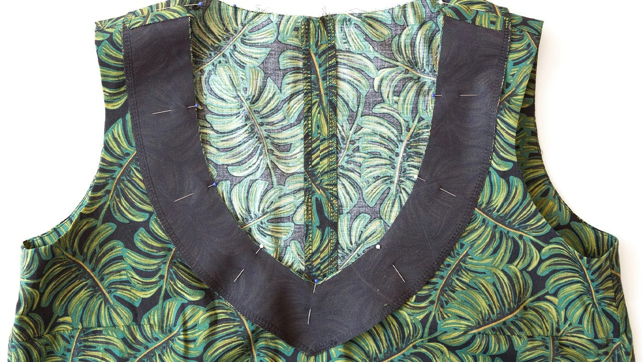 Hadley View B V-neckline flat lay showing fused facing pinned to palm leaf print bodice with clipped center front V-point