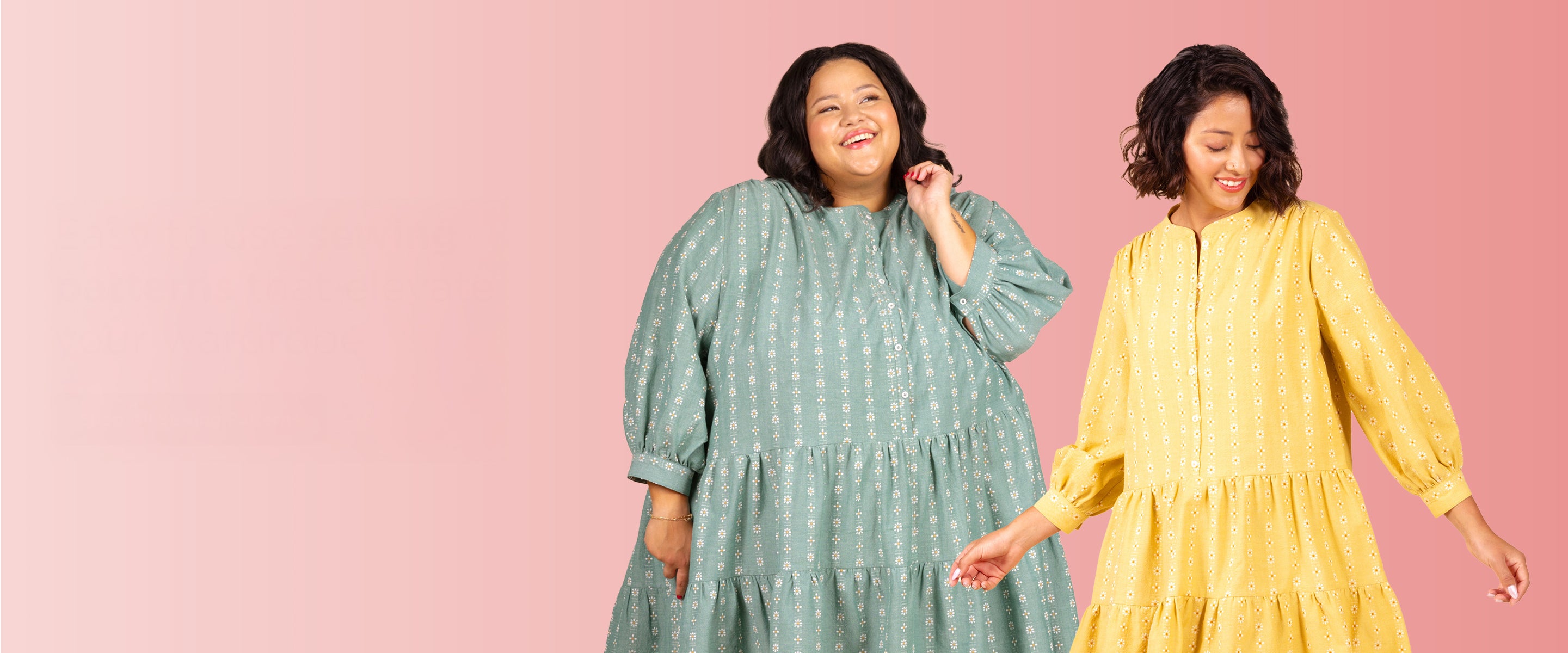Two women in tiered dresses with floral print, one in sage green and one in yellow, smiling against pink backdrop