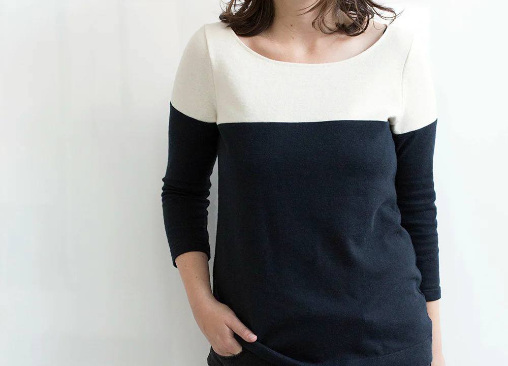 Colorblocked Lark Tee on model with cream upper body and navy lower body split at underarm seam with boat neck and 3/4 sleeves