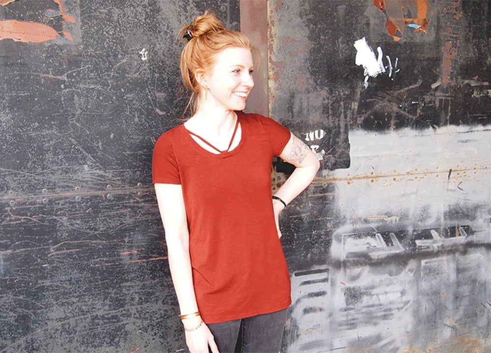Red Lark Tee on model showing fabric strap detail across scoop neckline from shoulders to center front with cap sleeves