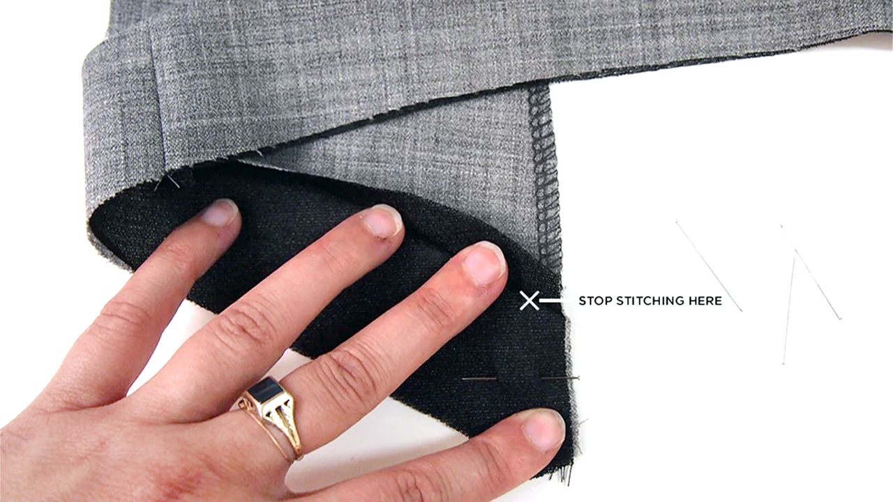Hand positioning Morris Blazer facing pieces showing where to stop stitching when joining front and hem facings together