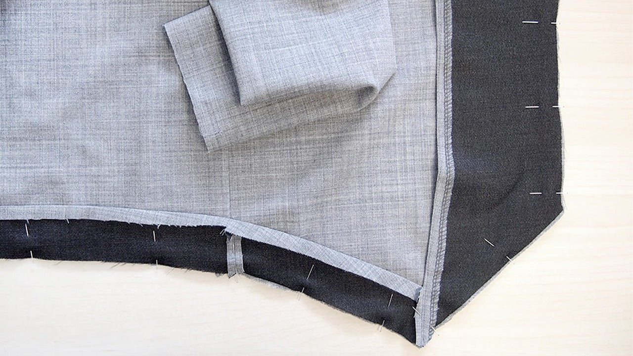 Morris Blazer hem corner showing interfaced facing pinned to the gray stretch wool blazer body