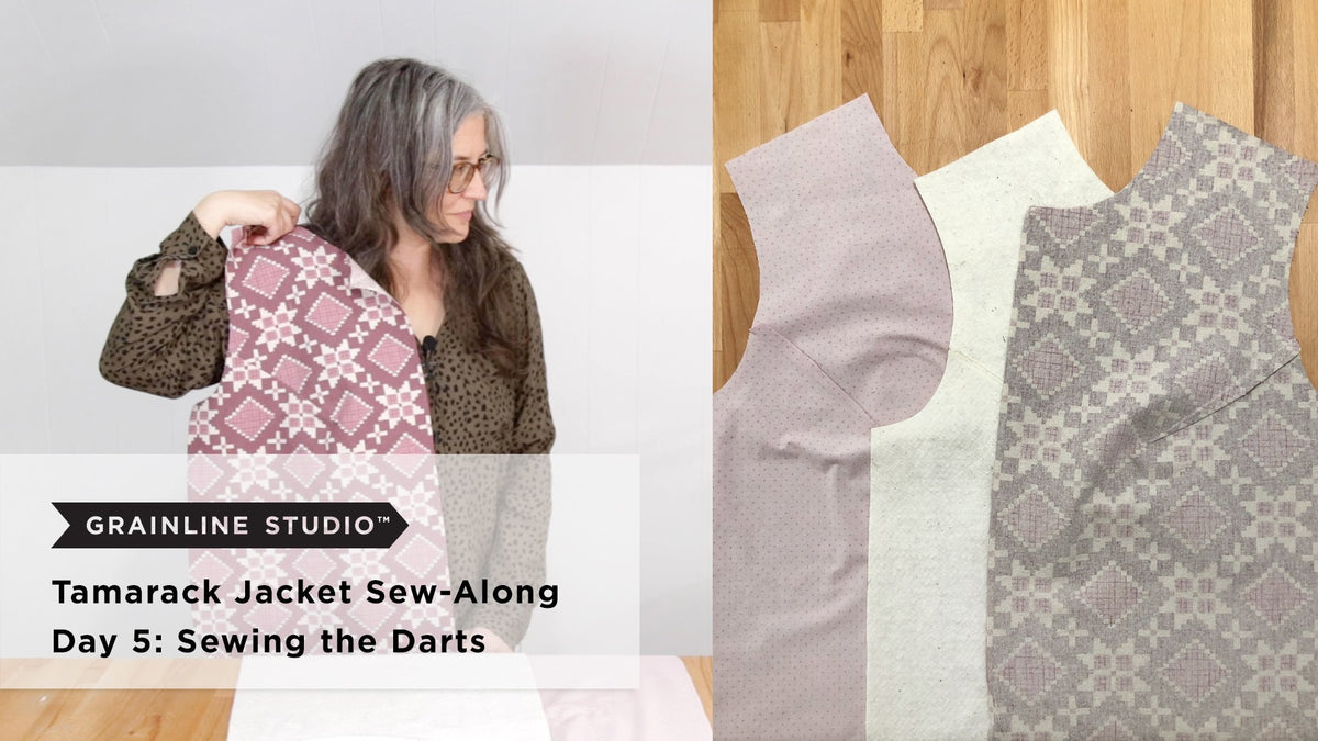 Three cut jacket front pieces including a pink printed shell, white batting, and pink dotted lining, fanned out on a wood surface showing the dart shaping on each layer