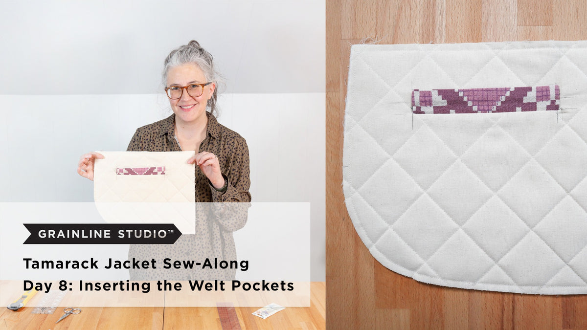 A quilted jacket front piece in cream fabric held up showing a completed welt pocket with a pink patterned welt insert on a wood surface