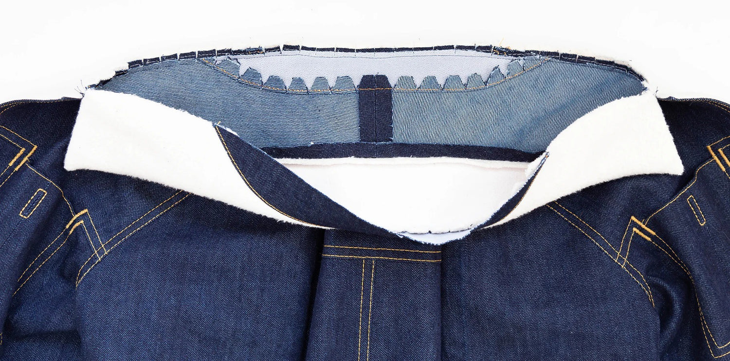 Thayer Jacket collar construction in navy denim showing collar stand attached to neckline with cream interfacing layers visible