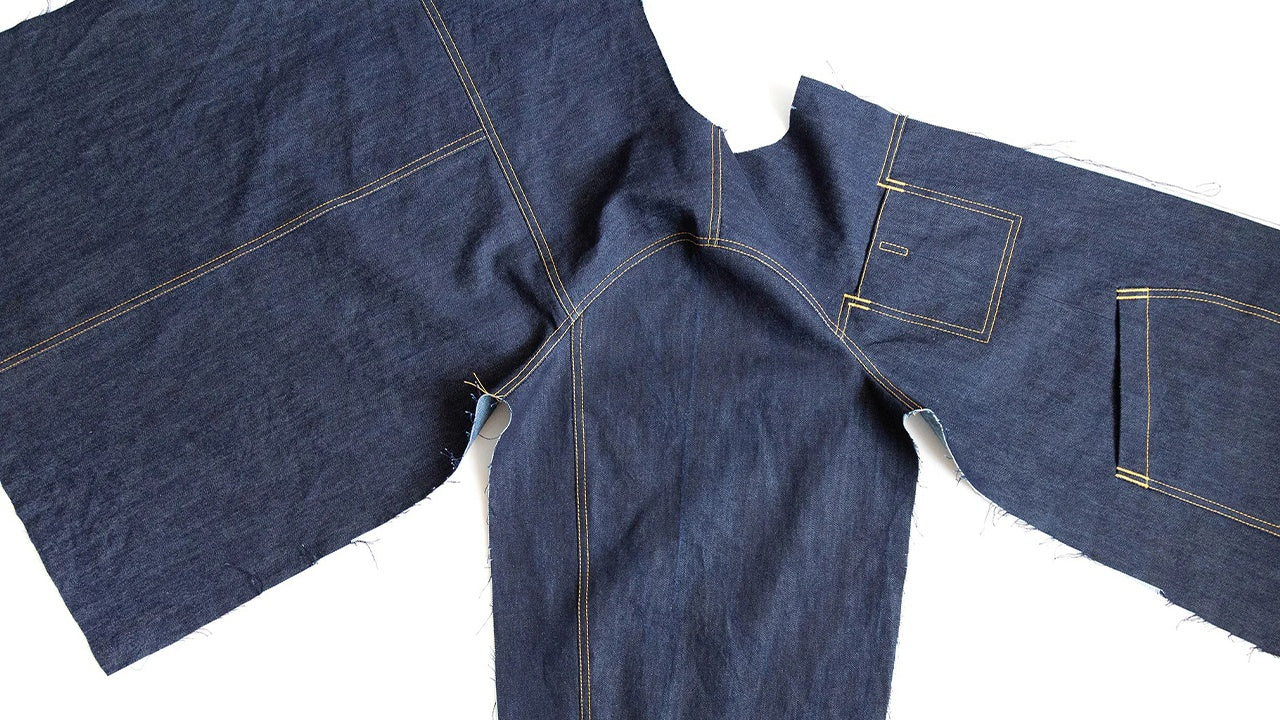 Thayer Jacket in navy denim showing shoulder seams, two-piece sleeves set flat, and continuous side seams with topstitching