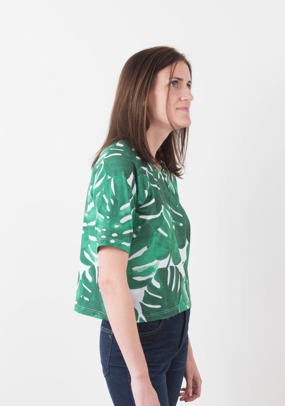 Side view of the short-sleeve Linden Sweatshirt with raglan sleeves in green monstera print knit.