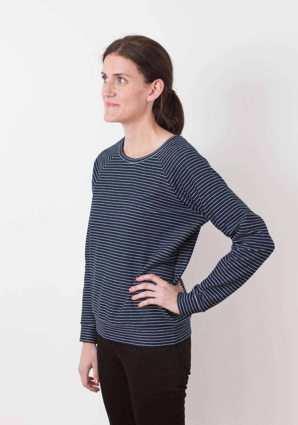 Model: Size 6, 5'8" | Side view of the long-sleeve striped Linden Sweatshirt, showing relaxed fit and curved hemline.