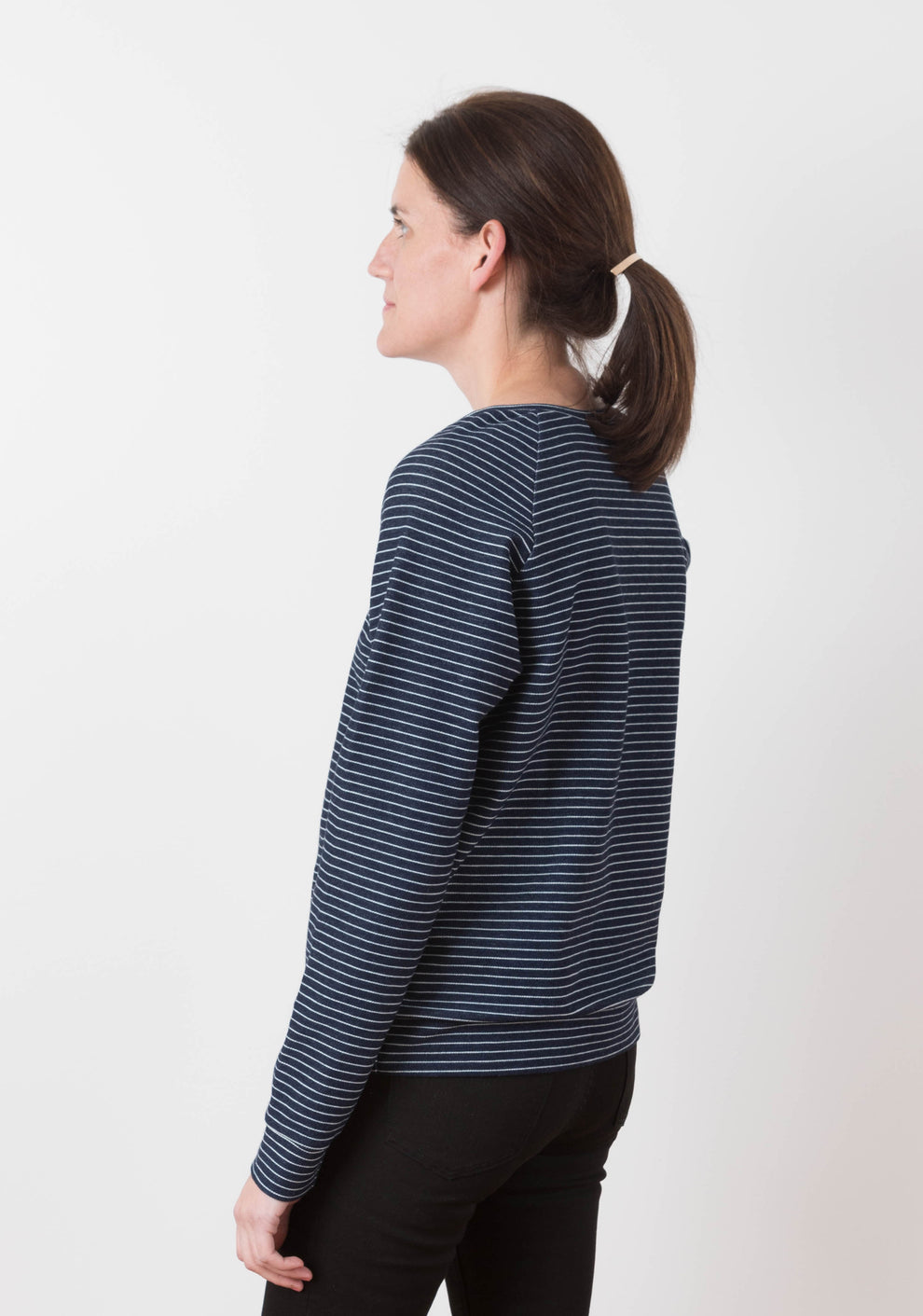 Back view of a long-sleeve Linden Sweatshirt in navy and white striped knit with raglan sleeves.