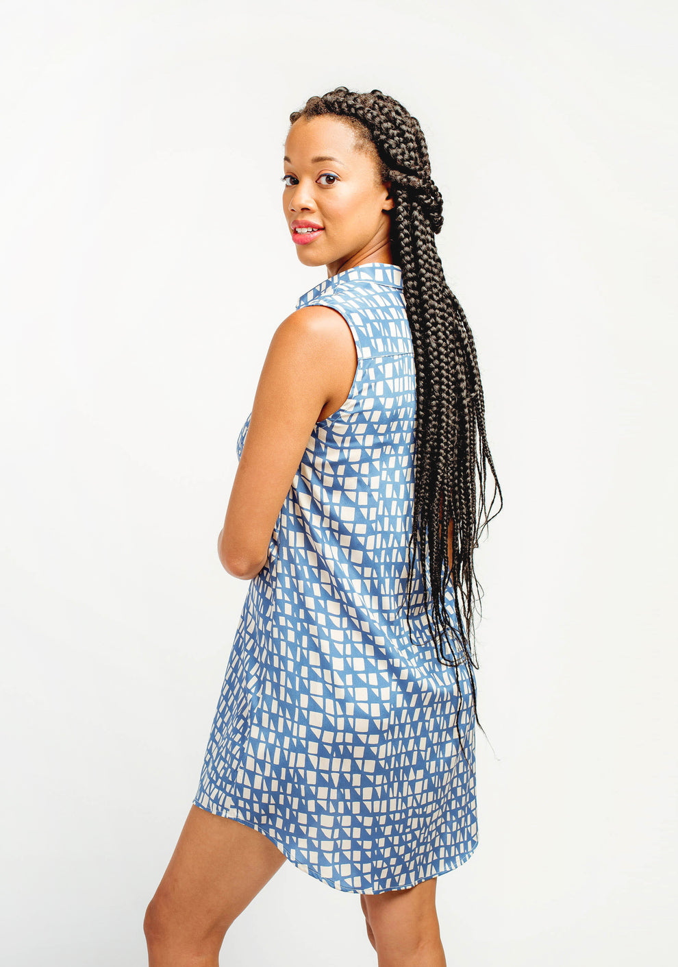Back view of blue printed Alder Shirtdress showing curved hem and sleeveless design.