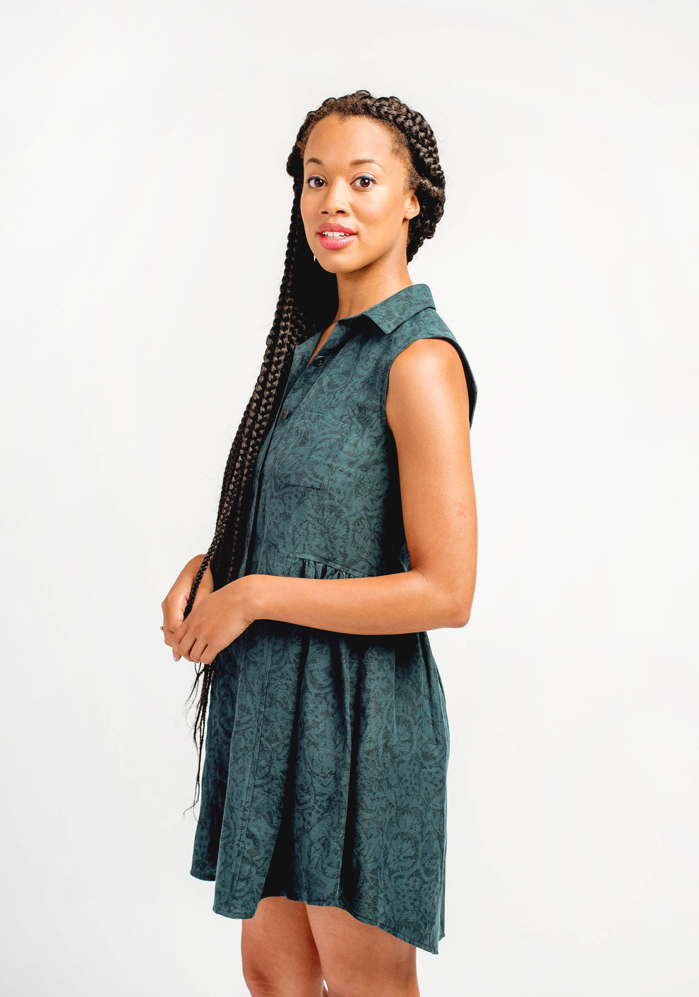 Back view of green Alder Shirtdress showing yoke, gathered skirt, and sleeveless design.