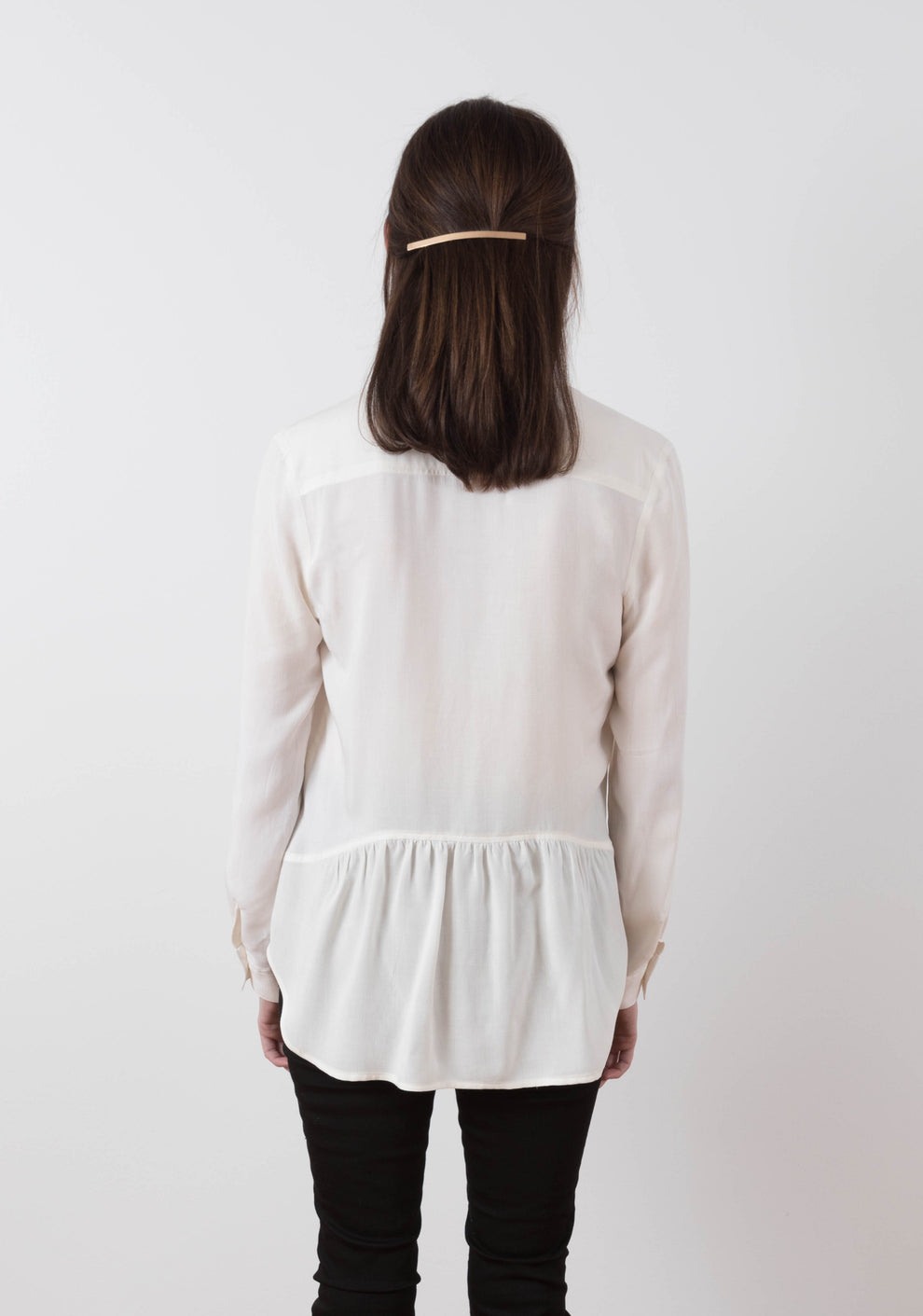 Back view of Archer View B shirt in white fabric with gathered lower back panel and long sleeves.