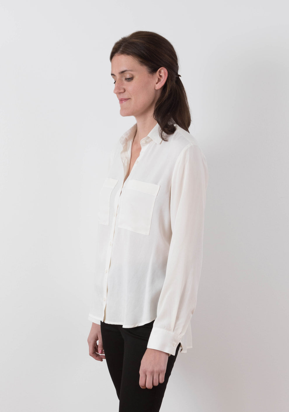 Front view of Archer View B shirt in white fabric, featuring drop hem, button front, and chest pockets.