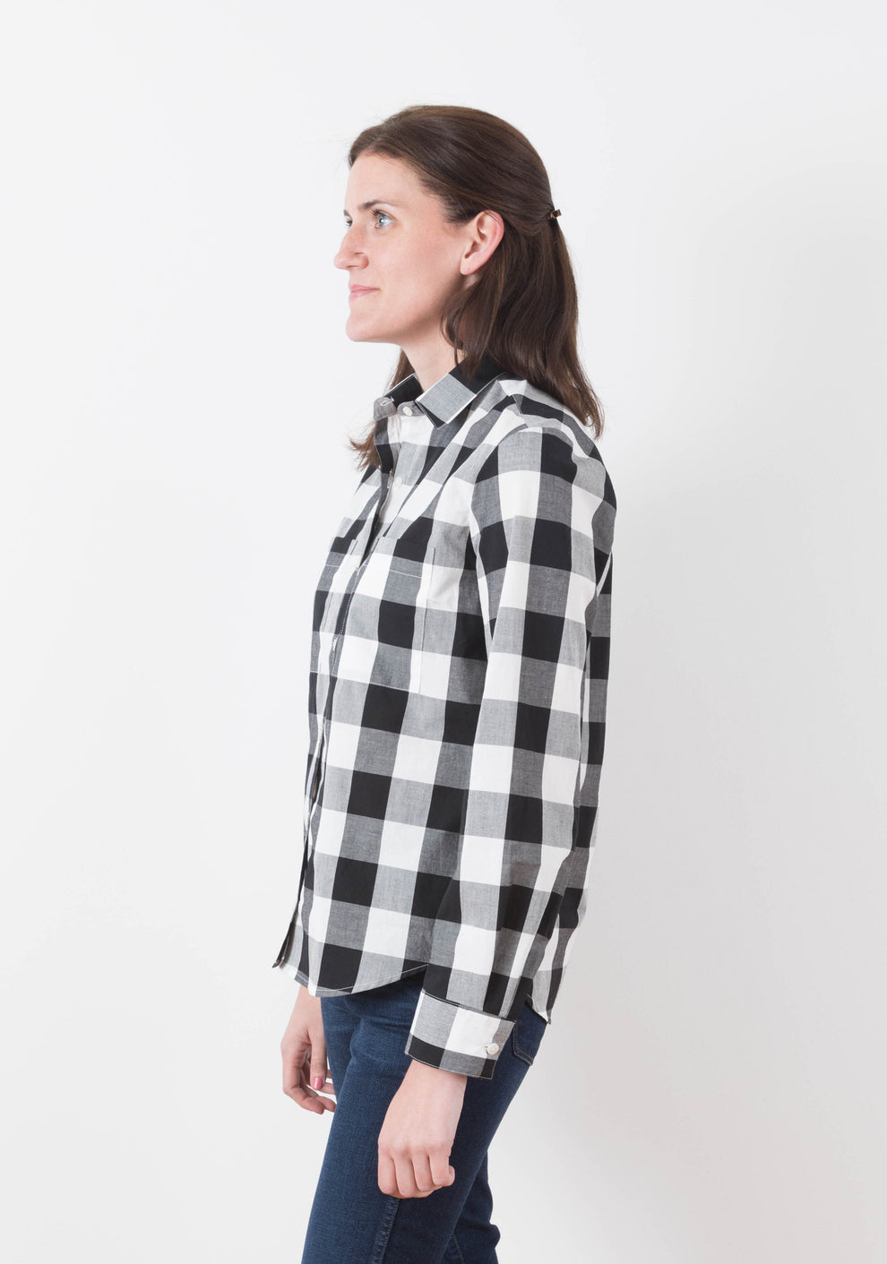 Side view of person wearing Archer View A shirt with long sleeves and curved hem in plaid cotton fabric.