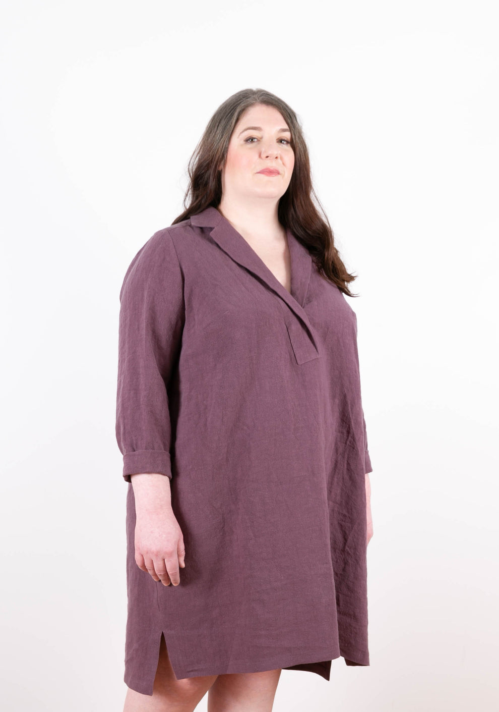 Side view of plum Augusta Dress highlighting drape and soft linen texture.